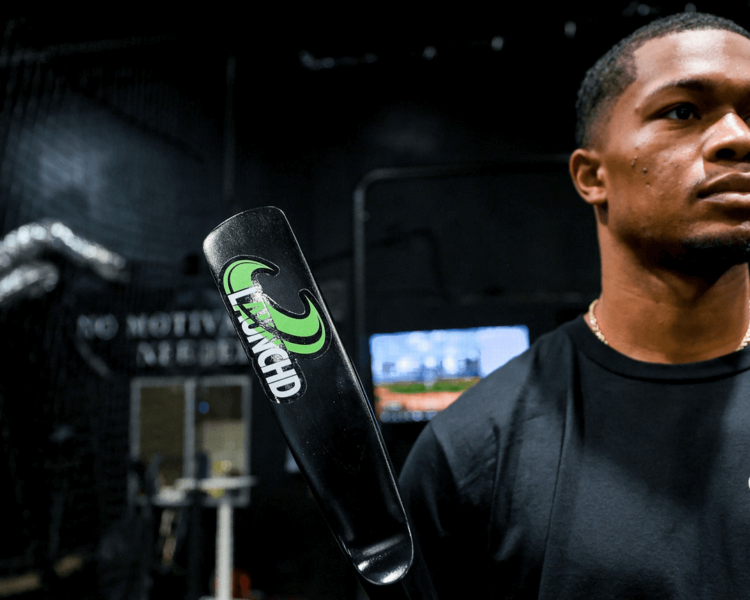 Person holding a paddle with a logo in an indoor setting