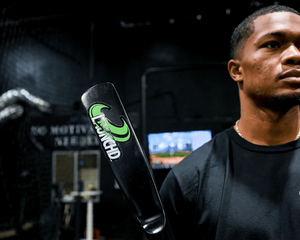 Person holding a paddle with a logo in an indoor setting